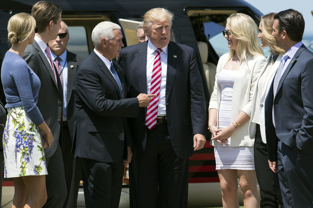 Republican presidential candidate Donald Trump, center, is greeted by vice presidential running mate Gov. Mike Pence, R-Ind., and family members after arriving near the site of the Republican National Convention, Wednesday, July 20, 2016, in Cleveland. (AP Photo/Evan Vucci)
